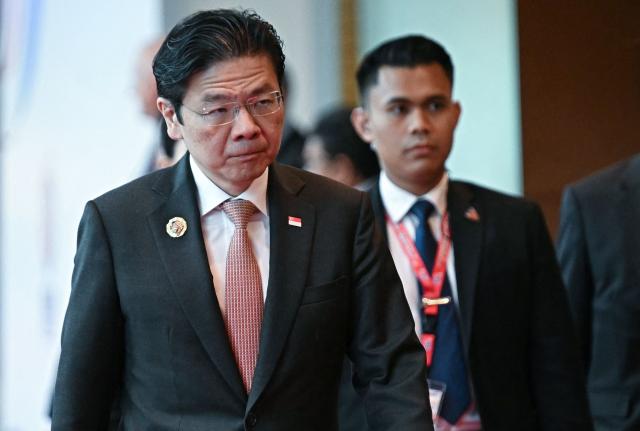 Singapore's Prime Minister Lawrence Wong walks between meetings during the 47th Association of Southeast Asian Nations (ASEAN) Summit in Kuala Lumpur on October 27, 2025. (Photo by Lillian SUWANRUMPHA / AFP)