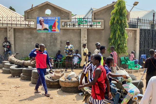 Supporters of Cameroonian opposition leader and presidential candidate Issa Tchiroma Bakary gather near barricades outside his residence following the announcement of presidential election results in Garoua on October 27, 2025. Cameroon's President Paul Biya, 92, has been re-elected for an eighth term with 53.7 percent of the vote, according to official results announced by the Constitutional Council on October 27, 2025. (Photo by AFP)