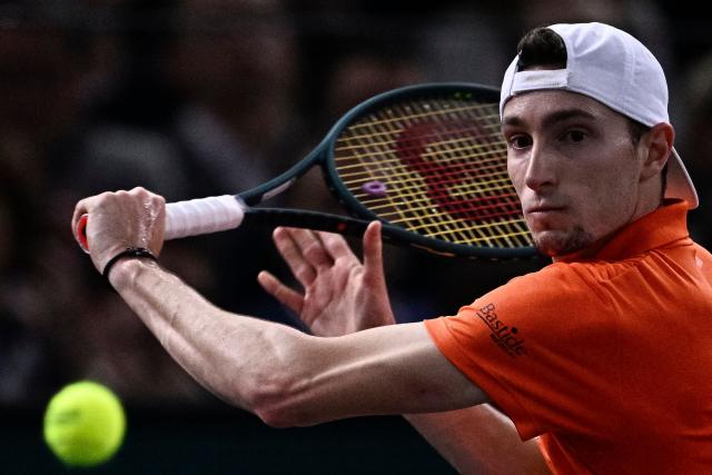 (FILES) France's Ugo Humbert plays a backhand return to Germany's Alexander Zverev during their men's singles final match on day seven of the Paris ATP Masters 1000 tennis tournament at the Accor Arena - Palais Omnisports de Paris-Bercy - in Paris on November 3, 2024. French number 1 Ugo Humbert has withdrawn from the Paris Masters, where he was a finalist in 2024, due to a back injury, the French Tennis Federation announced on October 27, 2025, on the first day of the tournament. (Photo by JULIEN DE ROSA / AFP)