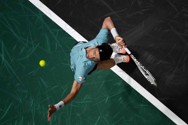TOPSHOT - France's Arthur Rinderknech serves to Hungary's Fabian Marozsan during their men's singles match on day one of the Paris ATP Masters 1000 tennis tournament at the Paris La Défense Arena in Nanterre, on the outskirts of Paris, on October 27, 2025. (Photo by François-Xavier MARIT / AFP)
