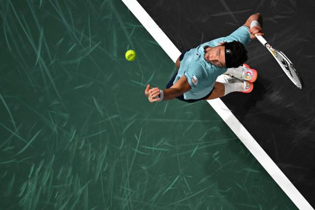 France's Arthur Rinderknech serves to Hungary's Fabian Marozsan during their men's singles match on day one of the Paris ATP Masters 1000 tennis tournament at the Paris La Défense Arena in Nanterre, on the outskirts of Paris, on October 27, 2025. (Photo by François-Xavier MARIT / AFP)