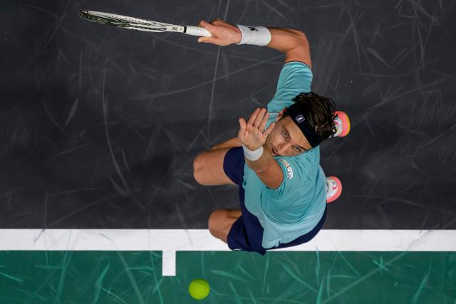 France's Arthur Rinderknech serves to Hungary's Fabian Marozsan during their men's singles match on day one of the Paris ATP Masters 1000 tennis tournament at the Paris La Défense Arena in Nanterre, on the outskirts of Paris, on October 27, 2025. (Photo by François-Xavier MARIT / AFP)