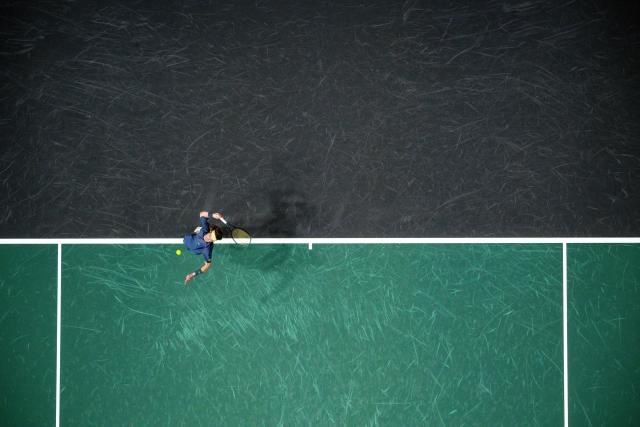 Andrey Rublev serves to  Britain's Jacob Fearnley during their men's singles match on day one of the Paris ATP Masters 1000 tennis tournament at the Paris La Défense Arena in Nanterre, on the outskirts of Paris, on October 27, 2025. (Photo by JULIEN DE ROSA / AFP)