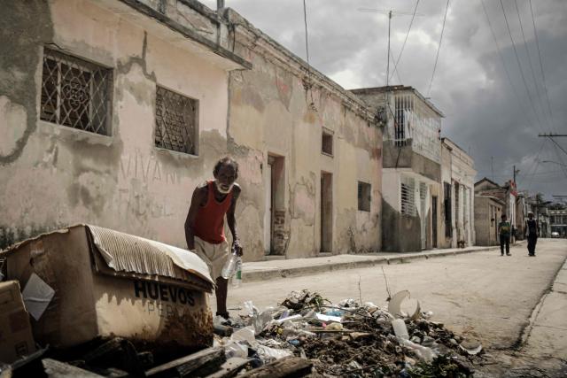 A man disposes of waste at a collection point ahead of the arrival of Hurricane Melissa in Santiago de Cuba, Cuba, on October 27, 2025. Hurricane Melissa strengthened Monday as it took aim at Jamaica and other parts of the Caribbean as a top-level Category 5 storm, with forecasters predicting catastrophic flooding and urging residents to seek shelter immediately. After passing over Jamaica, the storm was forecast to head north and cross over eastern Cuba on Tuesday night, while continuing to bring rain and heavy winds to Haiti and the Dominican Republic. (Photo by AFP)