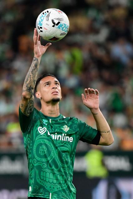 Real Betis' Brazilian forward #07 Antony catches a ball during the warmup before the Spanish league football match between Real Betis and Club Atletico de Madrid at the Cartuja Stadium in Seville on October 27, 2025. (Photo by CRISTINA QUICLER / AFP)