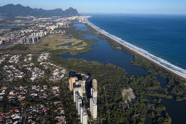 Aerial view of Barra de Tijuca neighbourhood in Rio de Janeiro, Brazil, taken on October 25, 2025. (Photo by Pablo PORCIUNCULA / AFP)