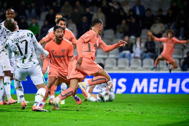FC Porto's Turkish forward #27 Deniz Gul (R) celebrates scoring their second goal during the Portuguese league football match between Moreirense FC and FC Porto at Comendador Joaquim de Almeida Freitas stadium in Moreira de Conegos on October 27, 2025. (Photo by Miguel RIOPA / AFP)