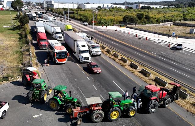 Aerial view of Jalisco farmers blocking the highway to Nogales to protest the price of corn and against the federal government in Zapopan, Jalisco state, Mexico on October 27, 2025. (Photo by ULISES RUIZ / AFP)