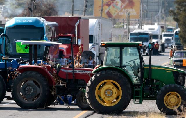 Tractors from Jalisco farmers block the highway to Nogales to protest the price of corn and against the federal government in Zapopan, Jalisco state, Mexico on October 27, 2025. (Photo by ULISES RUIZ / AFP)