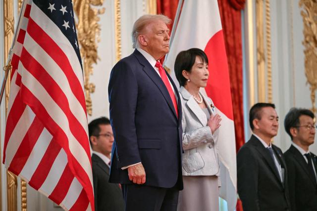 Japan's Prime Minister Sanae Takaichi (R) and US President Donald Trump review an honour guard of the Japan Self-Defense Force at the Akasaka State Guest House in Tokyo on October 28, 2025. (Photo by ANDREW CABALLERO-REYNOLDS / AFP)