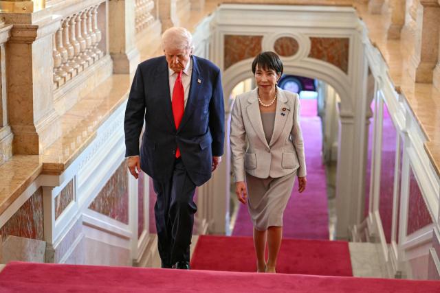 Japan's Prime Minister Sanae Takaichi (R) walks with US President Donald Trump upon his arrival at the Akasaka State Guest House in Tokyo on October 28, 2025. (Photo by ANDREW CABALLERO-REYNOLDS / AFP)