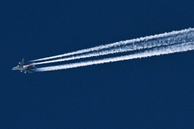 A Qantas Boeing A380 leaves a vapour trail over Melbourne on October 28, 2025, during it's flight from Sydney to Johannesburg in South Africa. (Photo by William WEST / AFP)