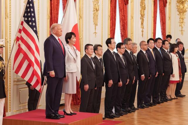 Japan's Prime Minister Sanae Takaichi and US President Donald Trump review an honour guard of the Japan Self-Defense Force at the Akasaka State Guest House in Tokyo on October 28, 2025. (Photo by Nicolas Datiche / POOL / AFP)