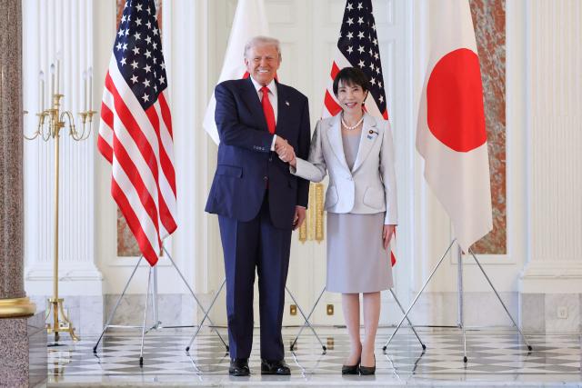 TOPSHOT - Japan's Prime Minister Sanae Takaichi (R) shakes hands with US President Donald Trump at the Akasaka State Guest House in Tokyo on October 28, 2025. (Photo by JAPAN POOL / JIJI PRESS / AFP) / Japan OUT