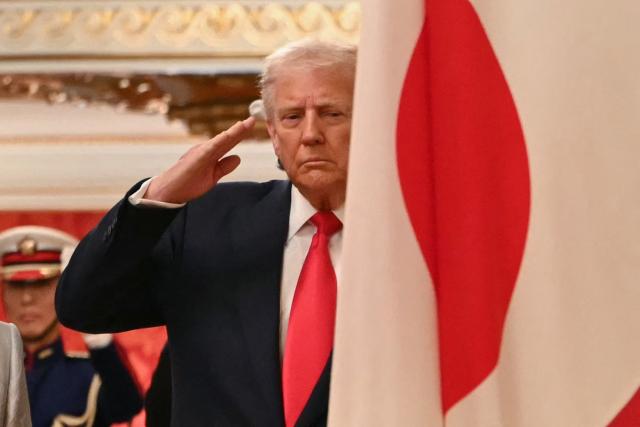 US President Donald Trump salutes during a review an honour guards of the Japan Self-Defense Force at the Akasaka State Guest House in Tokyo on October 28, 2025. (Photo by ANDREW CABALLERO-REYNOLDS / AFP)