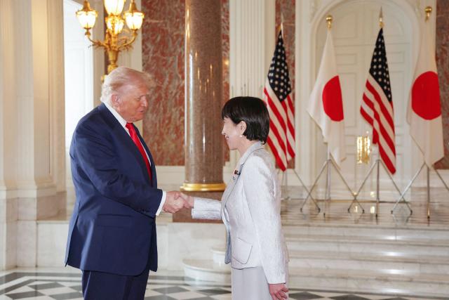 Japan's Prime Minister Sanae Takaichi (R) greets US President Donald Trump at the Akasaka State Guest House in Tokyo on October 28, 2025. (Photo by JAPAN POOL / JIJI PRESS / AFP) / Japan OUT