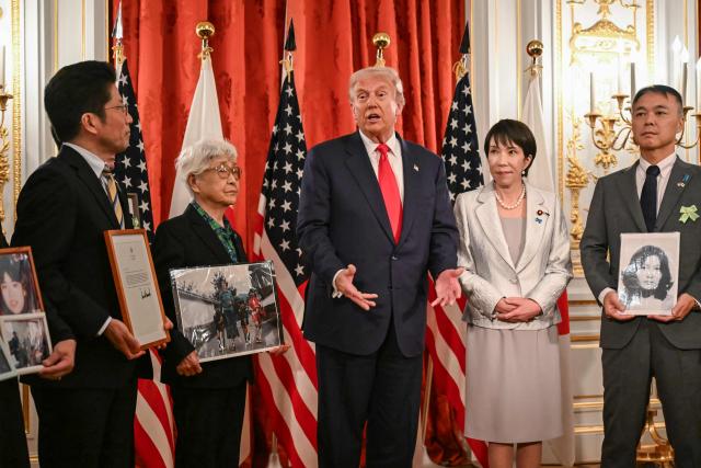 Family members of Japanese citizens abducted by North Korea meet with US President Donald Trump (C) and Japan's Prime Minister Sanae Takaichi (2nd R) at the Akasaka State Guest House in Tokyo on October 28, 2025. (Photo by ANDREW CABALLERO-REYNOLDS / AFP)