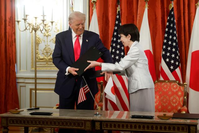 US President Donald Trump and Japan's Prime Minister Sanae Takaichi exchange documents during a signing ceremony for an agreement on critical minerals and rare earths at the Akasaka State Guest House in Tokyo on October 28, 2025. (Photo by Kiyoshi Ota / POOL / AFP)