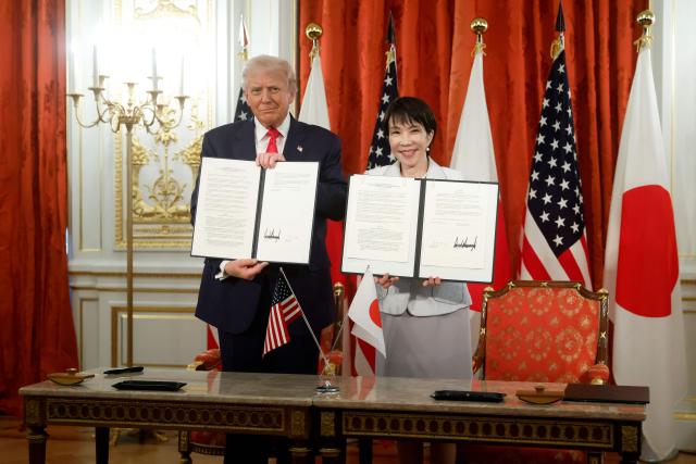 US President Donald Trump and Japan's Prime Minister Sanae Takaichi pose during a signing ceremony for an agreement on critical minerals and rare earths at the Akasaka State Guest House in Tokyo on October 28, 2025. (Photo by Kiyoshi Ota / POOL / AFP)