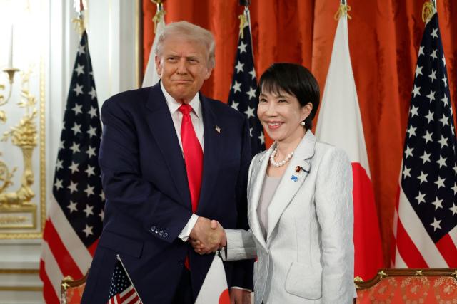 US President Donald Trump and Japan's Prime Minister Sanae Takaichi pose for photographs following a signing ceremony at the Akasaka State Guest House in Tokyo on October 28, 2025. (Photo by Kiyoshi Ota / POOL / AFP)