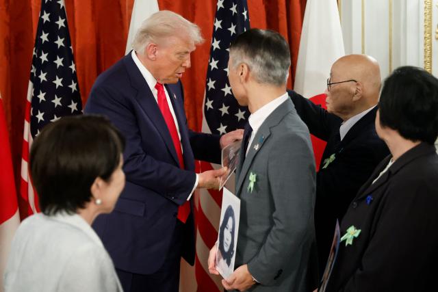 Family members of Japanese citizens abducted by North Korea meet with US President Donald Trump (2nd L) and Japan's Prime Minister Sanae Takaichi (L, back facing camera) at the Akasaka State Guest House in Tokyo on October 28, 2025. (Photo by Kiyoshi Ota / POOL / AFP)