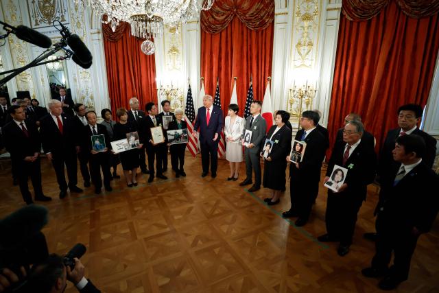 Family members of Japanese citizens abducted by North Korea meet with US President Donald Trump (centre L) and Japan's Prime Minister Sanae Takaichi (centre R) at the Akasaka State Guest House in Tokyo on October 28, 2025. (Photo by Kiyoshi Ota / POOL / AFP)
