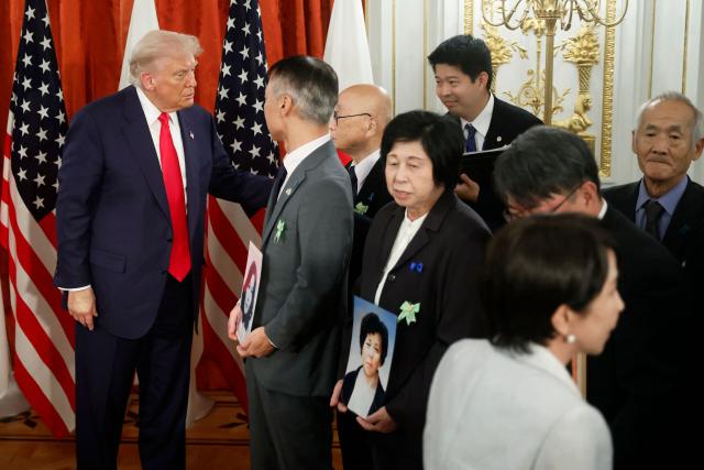 Family members of Japanese citizens abducted by North Korea meet with US President Donald Trump (L) and Japan's Prime Minister Sanae Takaichi (front R) at the Akasaka State Guest House in Tokyo on October 28, 2025. (Photo by Kiyoshi Ota / POOL / AFP)