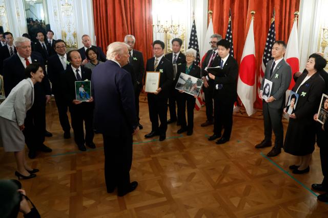 Family members of Japanese citizens abducted by North Korea meet with US President Donald Trump (C) and Japan's Prime Minister Sanae Takaichi (L) at the Akasaka State Guest House in Tokyo on October 28, 2025. (Photo by Kiyoshi Ota / POOL / AFP)