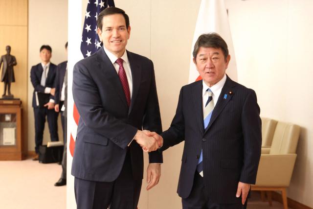 US Secretary of State Marco Rubio (L) shakes hands with his Japanese counterpart Toshimitsu Motegi (R) prior to their talks at the Foreign Ministry in Tokyo on October 28, 2025. (Photo by YOSHIKAZU TSUNO / POOL / AFP)