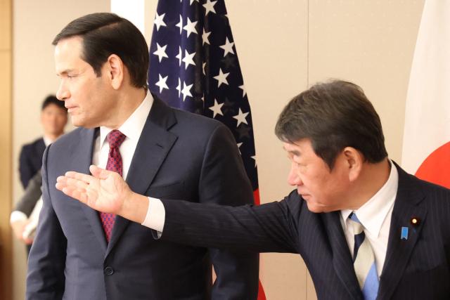 US Secretary of State Marco Rubio (L) is greeted by his Japanese counterpart Toshimitsu Motegi (R) prior to their talks at the Foreign Ministry in Tokyo on October 28, 2025. (Photo by YOSHIKAZU TSUNO / POOL / AFP)