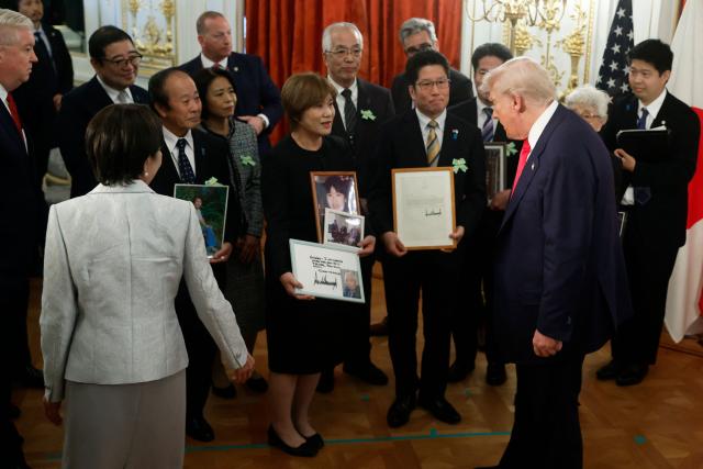 Family members of Japanese citizens abducted by North Korea meet with US President Donald Trump (R) and Japan's Prime Minister Sanae Takaichi (lower L) at the Akasaka State Guest House in Tokyo on October 28, 2025. (Photo by Kiyoshi Ota / POOL / AFP)