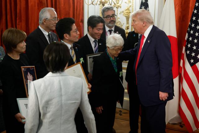 Family members of Japanese citizens abducted by North Korea meet with US President Donald Trump (R) and Japan's Prime Minister Sanae Takaichi (lower L) at the Akasaka State Guest House in Tokyo on October 28, 2025. (Photo by Kiyoshi Ota / POOL / AFP)