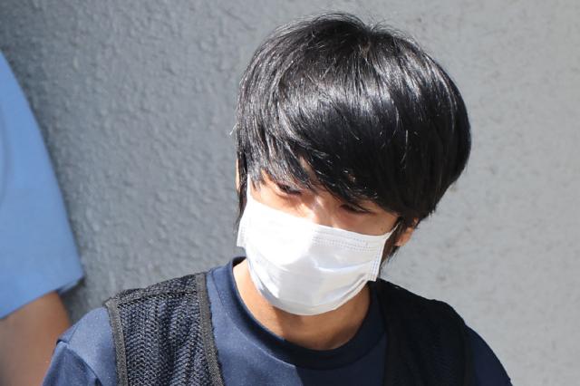 (FILES) Tetsuya Yamagami, the man accused of murdering former Japanese Prime Minister Shinzo Abe, is transferred from the Nara Nishi police station for psychiatric examination in Nara on July 25, 2022. A man accused of killing Japan's former prime minister Shinzo Abe pled guilty on October 28, 2025, three years after the assassination in broad daylight shocked the world. (Photo by JIJI PRESS / AFP) / Japan OUT