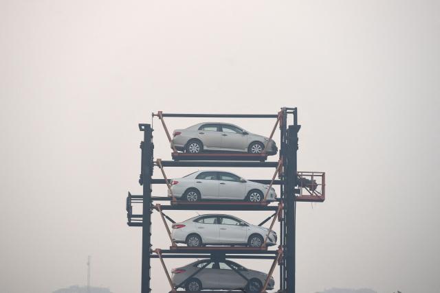 A general view of a Rotary Parking System amid dense smog in Lahore on October 28, 2025. (Photo by Syed Murtaza Ali / AFP)