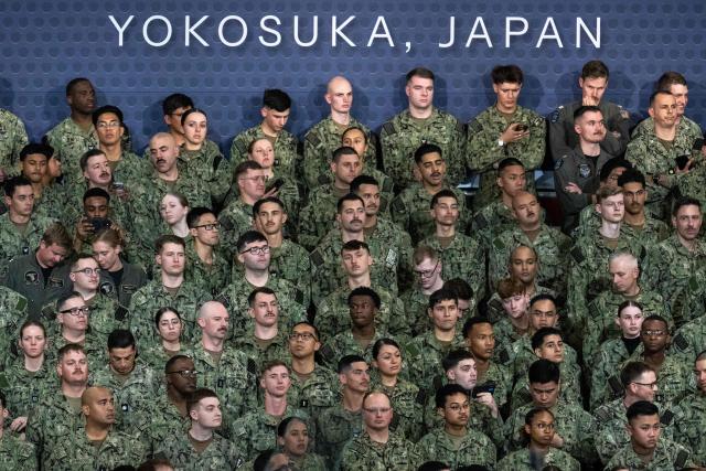US Navy personnel look on during US President Donald Trump's visit to the USS George Washington aircraft carrier at the US naval base in Yokosuka on October 28, 2025. (Photo by Philip FONG / AFP)