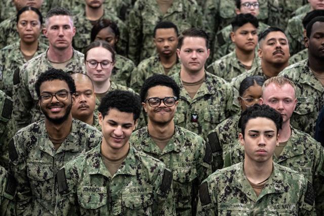 US Navy personnel look on during US President Donald Trump's visit to the USS George Washington aircraft carrier at the US naval base in Yokosuka on October 28, 2025. (Photo by Philip FONG / AFP)