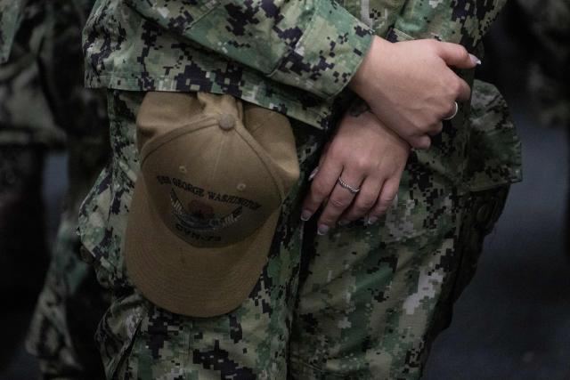 A member of the US Navy personnel stands during US President Donald Trump's visit to the USS George Washington aircraft carrier at the US naval base in Yokosuka on October 28, 2025. (Photo by Philip FONG / AFP)
