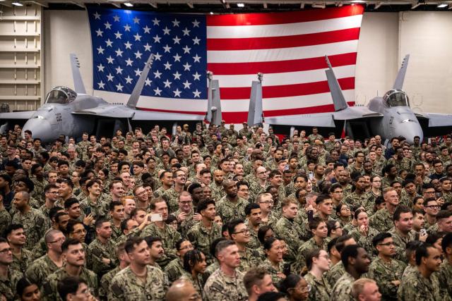 US Navy personnel look on during US President Donald Trump's visit to the USS George Washington aircraft carrier at the US naval base in Yokosuka on October 28, 2025. (Photo by Philip FONG / AFP)