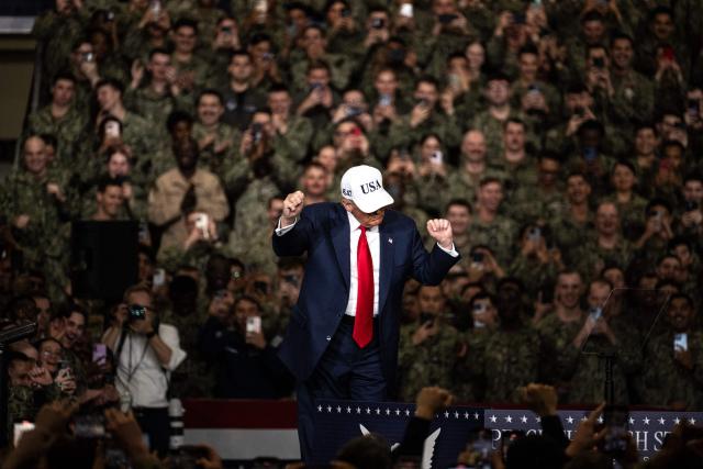 US President Donald Trump dances as he arrives to deliver a speech in front of US Navy personnel on board the US Navy's USS George Washington aircraft carrier at the US naval base in Yokosuka on October 28, 2025. (Photo by Philip FONG / AFP)