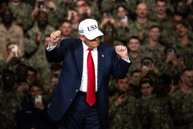 US President Donald Trump dances as he arrives to deliver a speech in front of US Navy personnel on board the US Navy's USS George Washington aircraft carrier at the US naval base in Yokosuka on October 28, 2025. (Photo by Philip FONG / AFP)