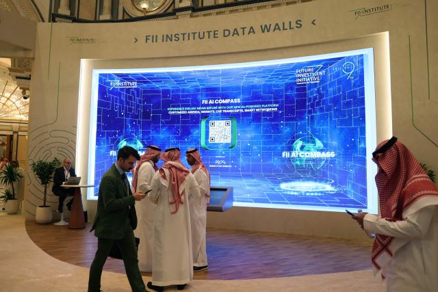 Guests attend the first day of the Future Investment Initiative, in Riyadh on October 28, 2025. Saudi Arabia opened a major investment conference featuring heads of state and the global business elite on October 28, 2025, as it seeks support for its sprawling "gigaprojects" and sky-high AI ambitions. (Photo by Fayez Nureldine / AFP)