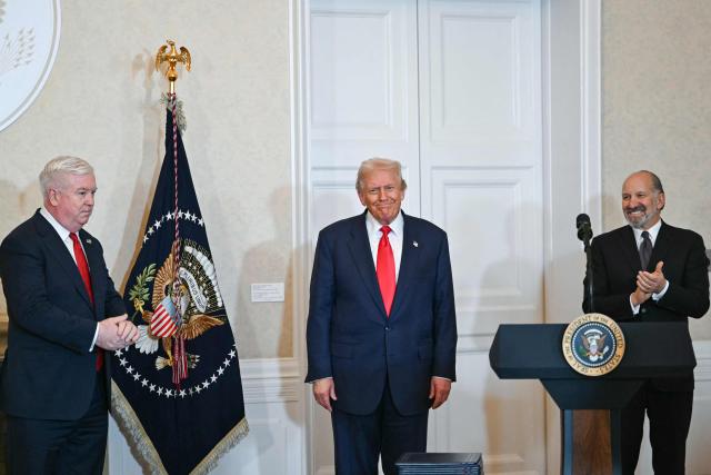 US Secretary of Commerce Howard Lutnick (R) and US Ambassador to Japan George Glass (L) applaud US President Donald Trump ahead of his speech at the US embassy in Tokyo on October 28, 2025. (Photo by ANDREW CABALLERO-REYNOLDS / AFP)