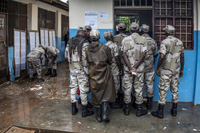 Members of different branches of Tanzania security forces queue at a voting centre in Langoni, on October 28, 2025 during the early vote ahead of October 29, 2025 General Election. (Photo by MARCO LONGARI / AFP)