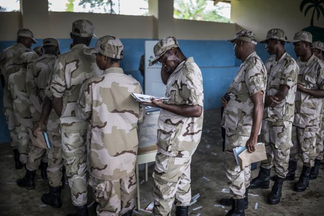 TOPSHOT - Members of different branches of Tanzania security forces queue at a voting centre in Langoni, on October 28, 2025 during the early vote ahead of October 29, 2025 General Election. (Photo by MARCO LONGARI / AFP)