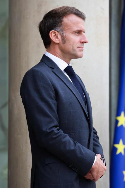 France's President Emmanuel Macron waits before welcoming Prince Rahim al-Hussaini, Aga Khan V, the 50th imam and spiritual leader of Shia Ismaili Muslims, upon his arrival at the Elysee Presidential Palace on the sideline of the Paris Peace Forum, in Paris, on October 28, 2025. (Photo by Ludovic MARIN / AFP)