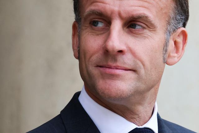 France's President Emmanuel Macron waits before welcoming Prince Rahim al-Hussaini, Aga Khan V, the 50th imam and spiritual leader of Shia Ismaili Muslims, upon his arrival at the Elysee Presidential Palace on the sideline of the Paris Peace Forum, in Paris, on October 28, 2025. (Photo by Ludovic MARIN / AFP)