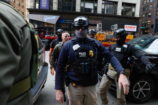 US Customs and Border Patrol Commander Gregory Bovino (2nd-L) arrives to federal court at Dirksen Federal Building in Chicago, Illinois on October 28, 2025. Bovino was ordered to appear in federal court for violating a temporary restraining order issued by District Judge Sara Ellis that orders immigration enforcement agents to limit use of tear gas and other crowd-suppression items except when there is an imminent threat. (Photo by KAMIL KRZACZYNSKI / AFP)