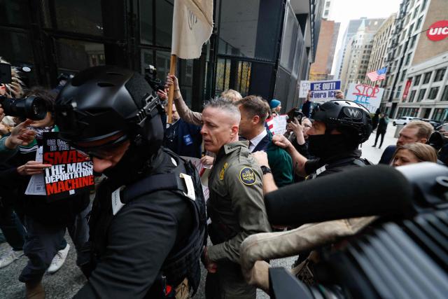 US Customs and Border Patrol Commander Gregory Bovino (C) arrives to federal court at Dirksen Federal Building in Chicago, Illinois on October 28, 2025. Bovino was ordered to appear in federal court for violating a temporary restraining order issued by District Judge Sara Ellis that orders immigration enforcement agents to limit use of tear gas and other crowd-suppression items except when there is an imminent threat. (Photo by KAMIL KRZACZYNSKI / AFP)