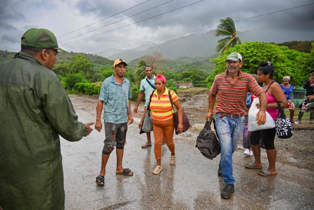 Residents are evacuated from Playa Siboney to safe locations ahead of the arrival of Hurricane Melissa, in Santiago de Cuba, Cuba, on October 28, 2025. Hurricane Melissa was set to strike nearby eastern end of Cuba late Tuesday after pummeling Jamaica. (Photo by YAMIL LAGE / AFP)