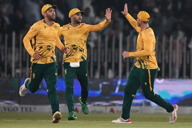 South Africa's players celebrate taking the wicket of Pakistan's Babar Azam (not pictured) during the first Twenty20 international cricket match between Pakistan and South Africa at the Rawalpindi Cricket Stadium in Rawalpindi on October 28, 2025. (Photo by Farooq NAEEM / AFP)